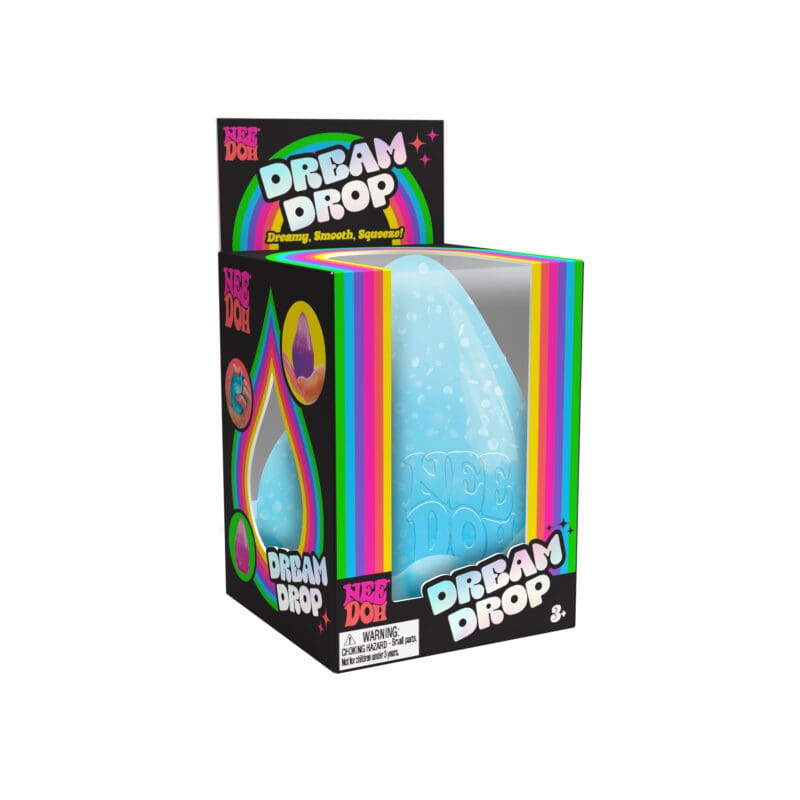 DRDND_Image2 A NeeDoh Dream Drop in its packaging. The packaging is primarily black with rainbow-colored accents and text that reads "Dream Drop" and "NeeDoh". The toy inside is a blue, drop-shaped, squeezable item. Suitable for ages 3 and up.